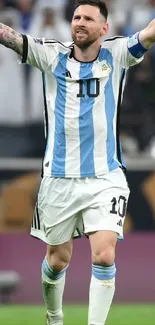 Soccer player celebrating on the field in a blue and white jersey.