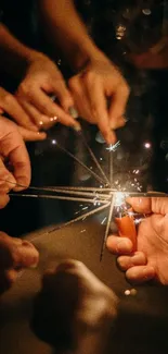 Hands holding sparklers in a festive celebration scene.