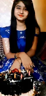 Woman in blue dress with birthday cake.