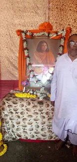 Ceremonial image with framed portrait and traditional decor.