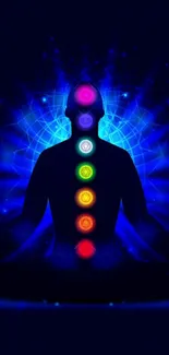 Silhouette with chakras in vibrant colors on dark background.