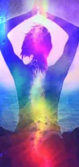 Silhouette meditating with a rainbow aura against a blue background.