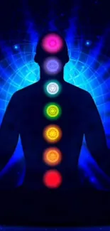 Meditative silhouette with chakras in vibrant blue and multi-color energy fields.