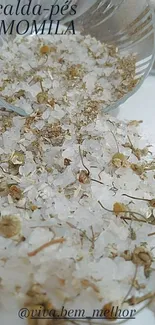 Close-up of chamomile and salt on a surface, evoking relaxation.