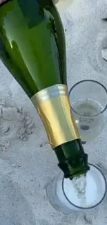 Champagne being poured into glasses on a sandy beach setting.