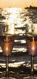 Champagne glasses on a beach with sunset view.