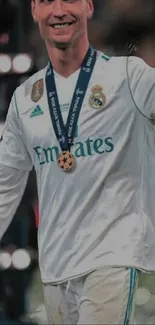 Football champion celebrating with medal.