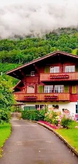 Alpine chalet surrounded by lush greenery and foggy hills.