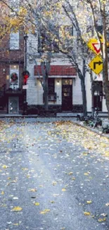 Serene autumn street with fallen leaves and quaint buildings.