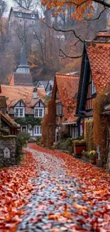 Charming village with autumn leaves on cobblestone path.