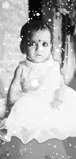 Charming baby portrait with snowflake effect in black and white style.