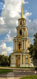 Baroque tower amidst lush green park under a clear blue sky.