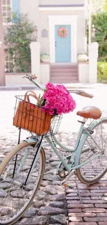 Vintage bicycle with pink roses on a sunny stone path.