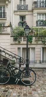 Bicycle resting in front of classic building facade with greenery.