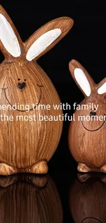 Wooden bunny figurines on black background, symbolizing family love.