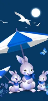 Bunnies under an umbrella with a dark blue night sky.