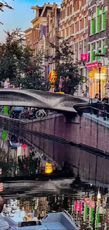 Picturesque canal with city architecture at dusk, reflecting lights in the water.