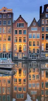 Amsterdam canal houses reflecting on tranquil water.