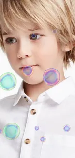 Portrait of a young child with blonde hair wearing a white button-up shirt.