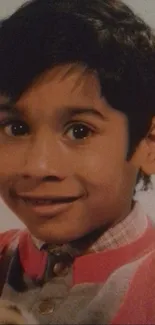 Portrait of a smiling young boy in red clothing.