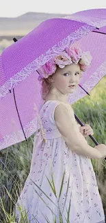 Child in meadow with pink umbrella and floral crown.