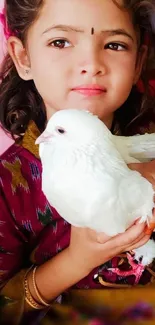 A child holds a white dove, evoking innocence and peace in a heartwarming portrait.