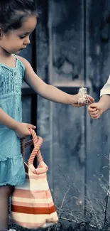 Two children play with a dandelion in a rustic outdoor setting.