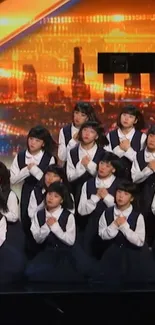 Choir in uniform performs against a glowing city backdrop.