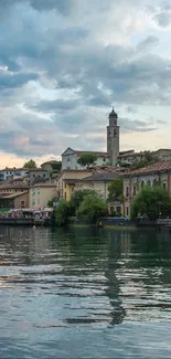 Charming coastal town at dusk with mountains and water reflections.