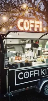 Cozy coffee truck with glowing lights and outdoor ambience.