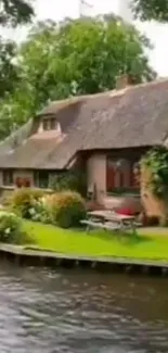 Riverside cottage amidst lush greenery and calm waters.