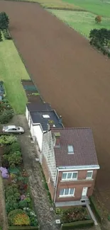 Aerial view of charming countryside with fields and house.