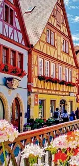 Charming European village street with colorful houses and flowers.