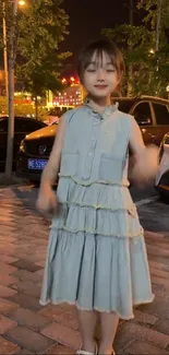 Young girl smiling on city street at night.