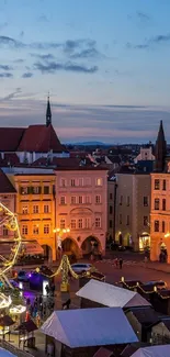 Scenic evening view of town with colorful buildings and Ferris wheel.