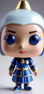 Charming toy figurine with blue outfit and gold accents on a white background.