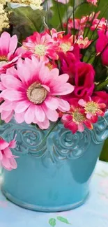 Vibrant flowers in a blue vase wallpaper.