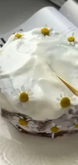 Charming cake with white icing and yellow flowers on a plate.