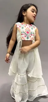 Smiling young girl in floral dress.