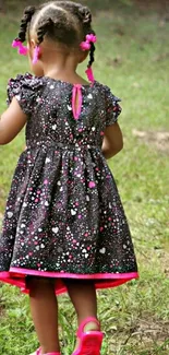 Young girl in a colorful dress walking through nature.