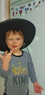 Child with a hat and glowing hearts decor.