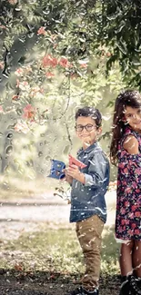 Two joyful children in a vibrant garden setting with flowers.