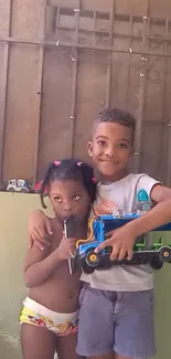 Two kids playing in a cozy home setting with toys and smiles.