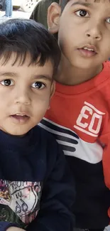 Adorable picture of two children in stylish sweatshirts.