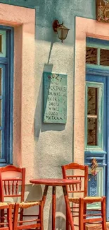 Mediterranean café scene with colorful façade and wooden chairs.