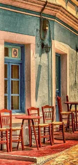 Mediterranean café with colorful red chairs outside a rustic building.