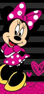 Minnie Mouse in pink polka-dot dress with heart design background.