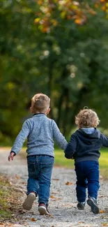 Two kids walking on a leafy path.