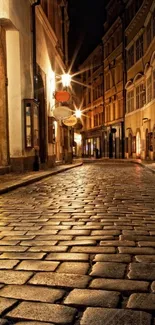 Cobblestone street at night with glowing street lamps.