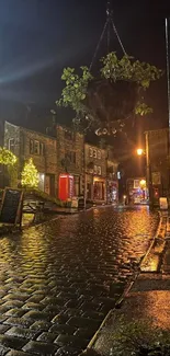 Cobblestone street illuminated at night with urban charm.